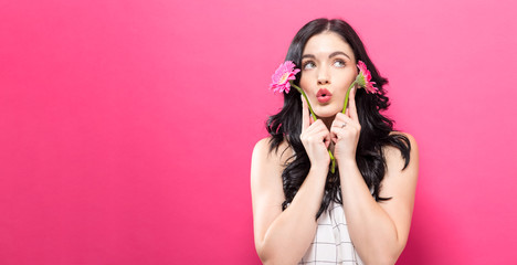Young woman with garbela on a pink background
