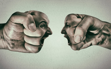Two fists with a male and female face collide with each other on light background. Concept of...