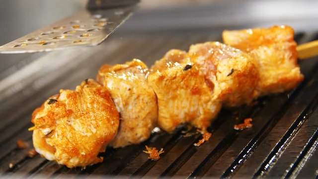 Closeup Slow Motion Cooker Touches Meat with Spatula