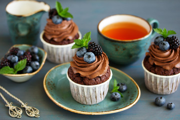 Chocolate cupcakes, with chocolate cream and fresh berries.