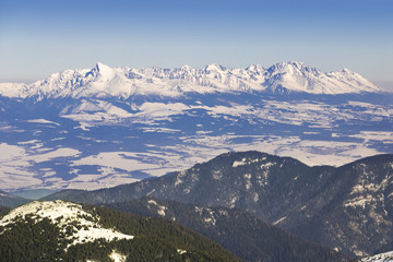 Fototapeta na wymiar Ski resort in Slovakia. High mountain Tatras. Peak Chopok on sunny day. Beautiful landscape.