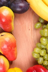 Fruits and vegetables on a wooden background with a place for an inscription for the designer