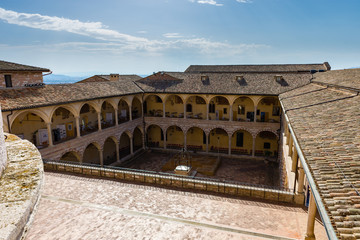 Famous Basilica of St. Francis of Assisi (Basilica Papale di San Francesco) at sunset in Assisi