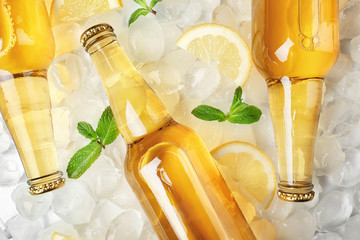 Bottles of lemonade on ice background - obrazy, fototapety, plakaty