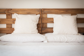wooden bed with white linen