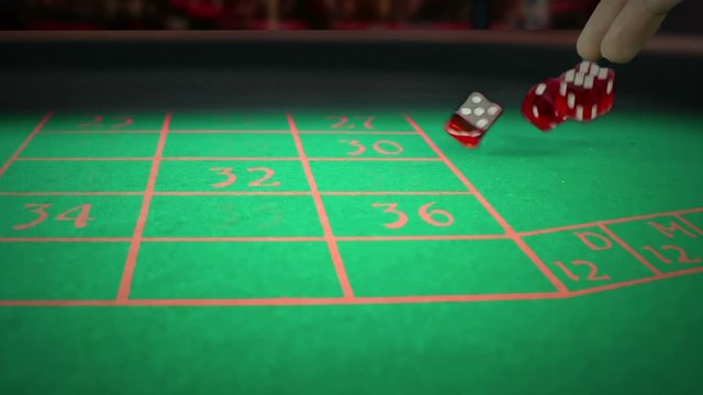 three red dice rolling on green game gambling table on light disco, shooting with slow motion, concept of sport recreation leisure game in the casino
