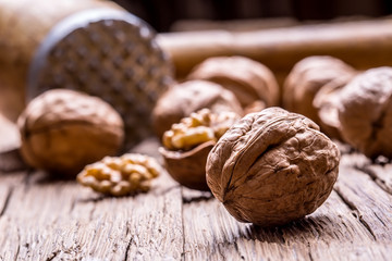 Walnut. Walnut kernels and whole walnuts on rustic old oak table