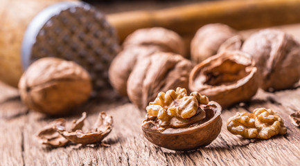 Walnut. Walnut kernels and whole walnuts on rustic old oak table