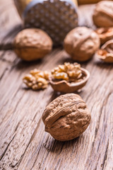 Walnut. Walnut kernels and whole walnuts on rustic old oak table