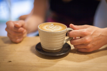 cappuccino on a wooden table ready for you to enjoy