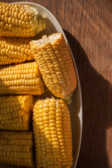 Corn cobs on the plate close up