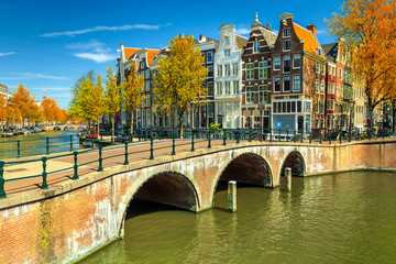 Obraz premium Typical Amsterdam canals with bridges and colorful houses, Netherlands, Europe