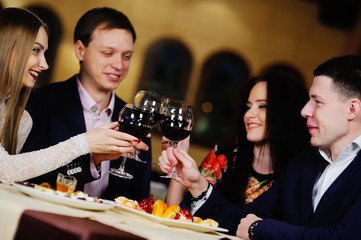 a group of friends in the restaurant celebrates