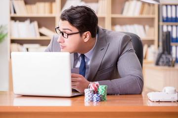 Businessman gambling playing cards at work