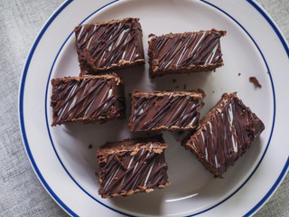 A white plate with chocolate cakes, top view.