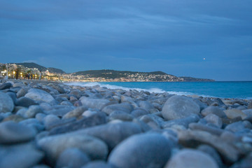 Beach of Nice, France. Blurred Foreground with pebbles