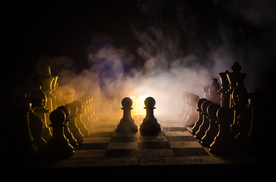 chess board game concept of business ideas and competition and strategy ideas concep. Chess figures on a dark background with smoke and fog.