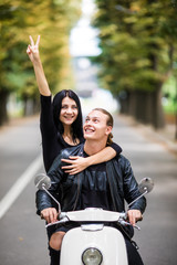 Couple in love riding a motorbike, Handsome guy and young sexy woman travel . Young riders enjoying themselves on trip. Adventure and vacations concept.