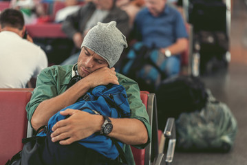 Exhausted guy is sleeping on bench