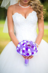colourful wedding bouquet in bride's hands white background