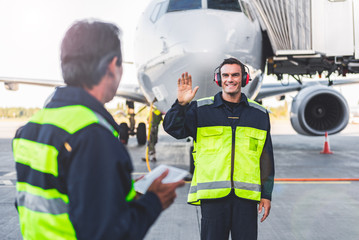 Outgoing mechanic waving hands to colleague