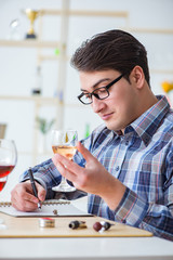 Professional sommelier tasting red wine 