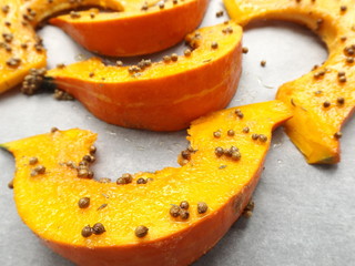 Pumpkin prepared for baking with garlic and coriander