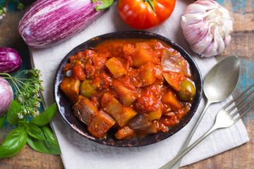 Best italian food - sicilian caponata with eggplants, tomatoes, onion, garlic and herbs