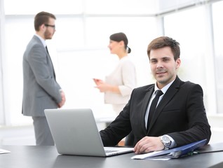Fototapeta premium successful businessman sitting at Desk in office
