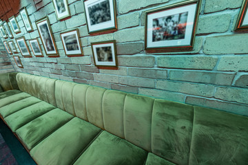 Lounge bar interior with brick wall and big sofa