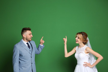 Happy wedding couple on color background