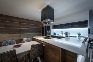 Table with seats and counter top in kitchen