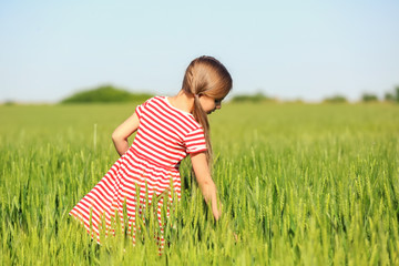 Little girl in green field