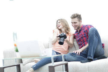 happy young couple checks photos on photos the camera