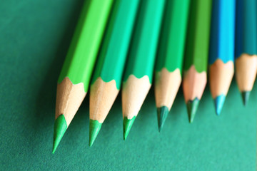 Many pencils on green background