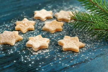 Christmas composition with raw cookies and fir tree branch on dark background