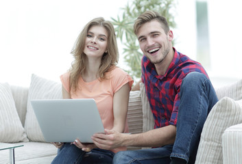 smiling couple resting at home,sitting on the couch.