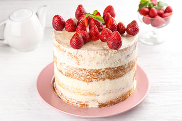 Delicious strawberry cake on wooden table
