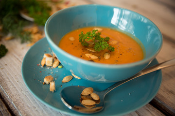 Pumpkin soup served with parsley and pumpkin seeds / Autumn concept