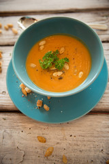 Pumpkin soup served with parsley and pumpkin seeds / Autumn concept