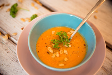 Pumpkin soup served with parsley and pumpkin seeds / Autumn concept