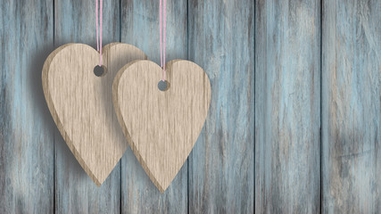 Dwa serca zawieszone na sznurku na tle ściany z drena