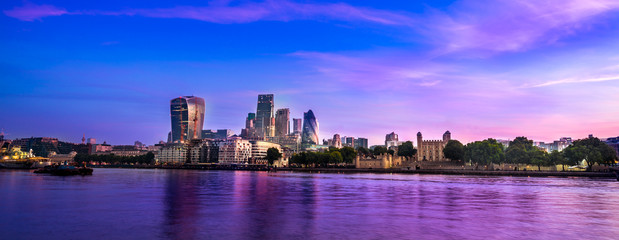London panorama. Riverside.Skyscrapers of the City of London over the Thames , England UK at beautiful magenta sunrise