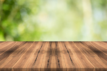 Naklejka na ściany i meble Wood table top on nature green blurred background,for montage your products