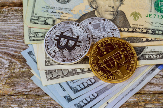 Top view of the gold coins bitcoin on a dollar bill. The concept of crypto currency.