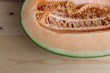 Half Melon sweet fruit with seed on wood table