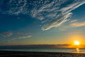 Fototapeta na wymiar morning sun and blue sky over the ocean on a calm morning