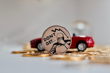 Bitcoin coin near red car