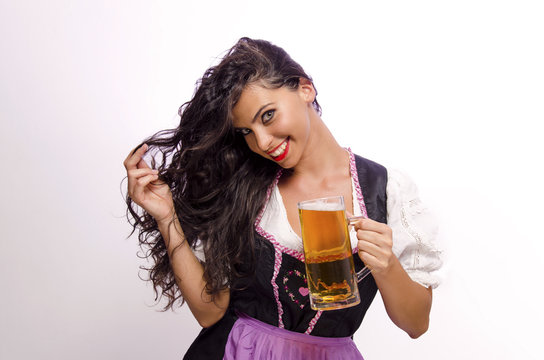 Portrait of beautiful long hair brunette holding beer mug, studio shot 