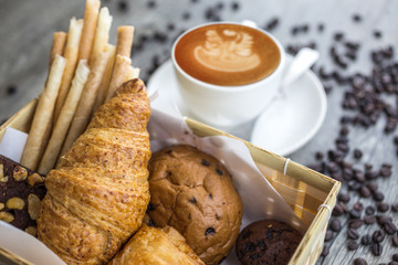 bread and rolls on old wood background (bread, bakery, basket, coffee)